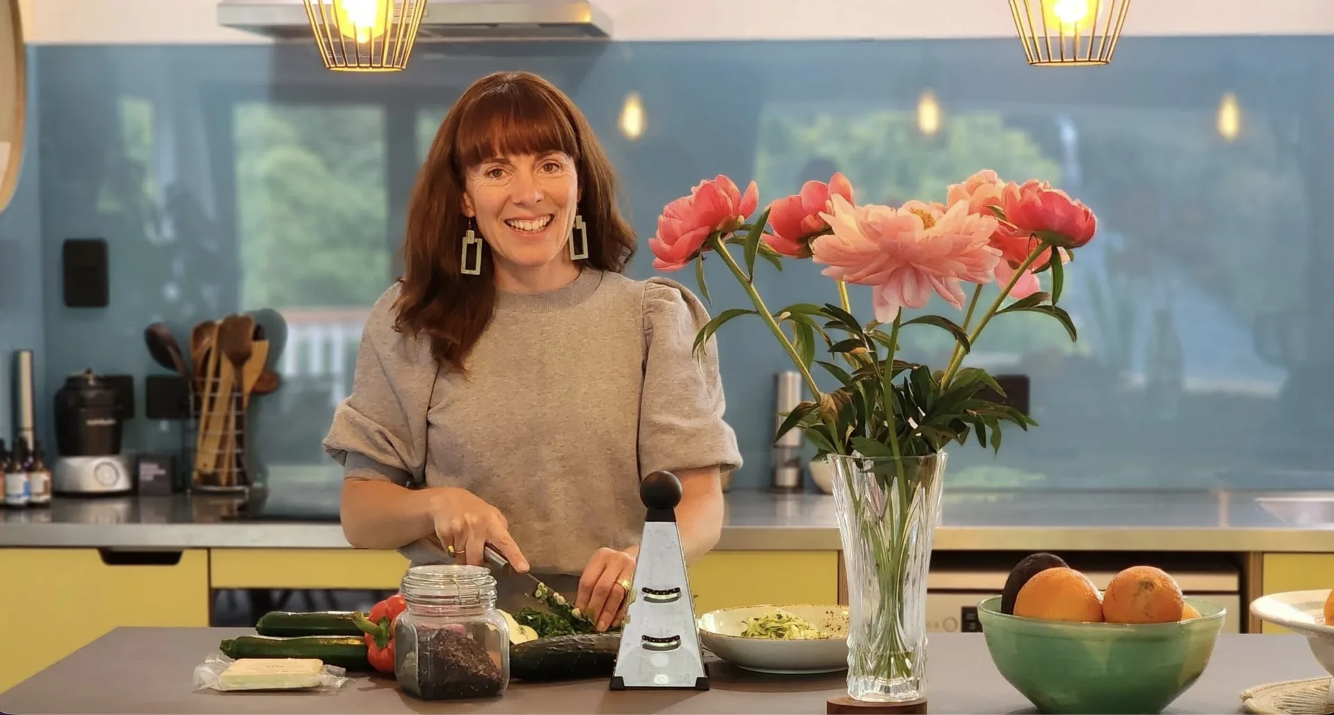 Jasmine June cooking in her kitchen with fresh ingredients
